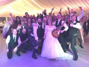 bride and groom with guests and fife wedding band the dirty martinis cow shed crail DIY wedding barn