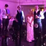 bride and groom with band fife wedding band the dirty martinis balbirnie house hotel