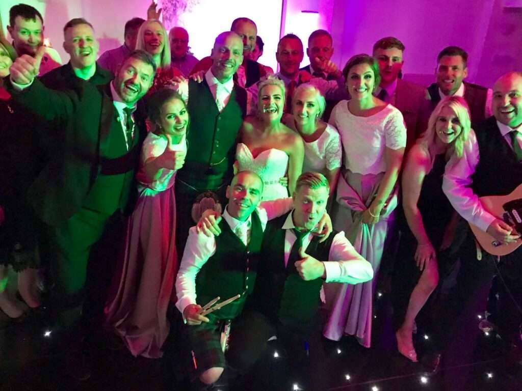 bride and groom with band fife wedding band the dirty martinis balbirnie house hotel