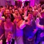 wedding guests smiling and happy with fife wedding band the dirty martinis.